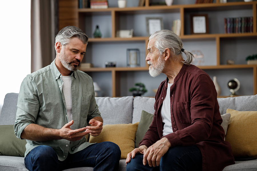Son is talking to his elderly father about the benefits of living in a senior community.